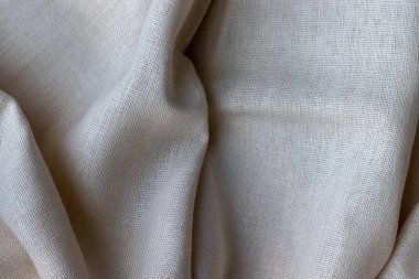 Doğal keten kumaş dokusu. Buruşuk buruşuk çuval bezi. Seçici odaklanma. Yakın görünüm