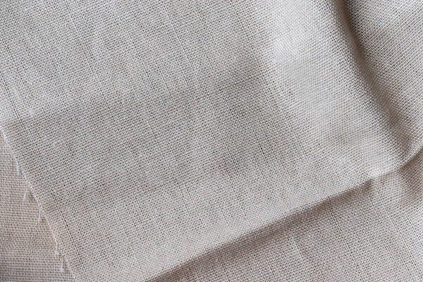 Natural beige linen fabric texture. Rough crumpled burlap background