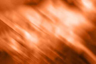 Turuncu renkli bulanık arkaplan. Karışık hareket dokusu. Soyut köşegen çizgiler duvar kağıdı