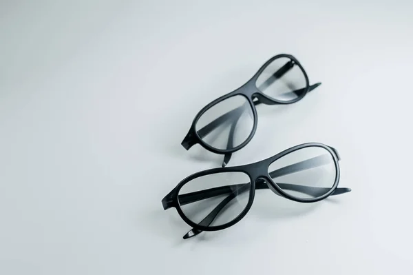 सिनेमासाठी दोन जोड्या 3 डी चष्मा. 3 डी मध्ये चित्रपट पहात आहे. काळा चष्मा . — स्टॉक फोटो, इमेज