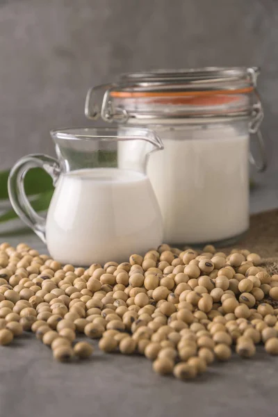 Milk jars with pile of Soybeans