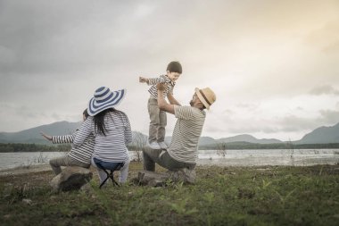 Genç kızı ve oğluyla yakın göl piknik üzerinde üst. Aile kavramları