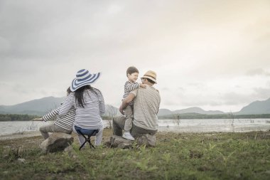 Genç kızı ve oğluyla yakın göl piknik üzerinde üst. Aile kavramları