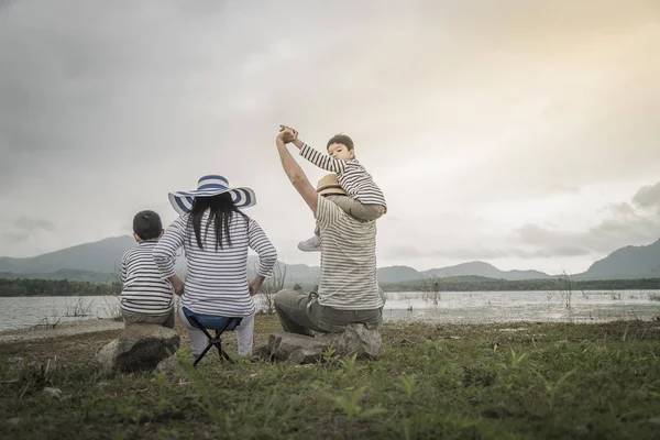 Genç kızı ve oğluyla yakın göl piknik üzerinde üst. Aile kavramları