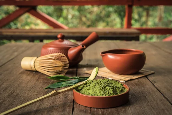 Brewing green tea powder, Still life with Japanese matcha accessories and green tea in bowl.