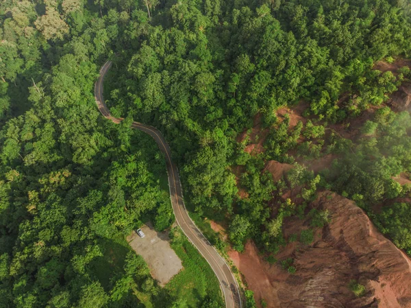 Top View of Rural Road, Path through the green forest and countr