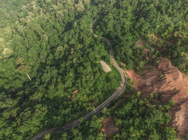 Top View of Rural Road, Path through the green forest and countr