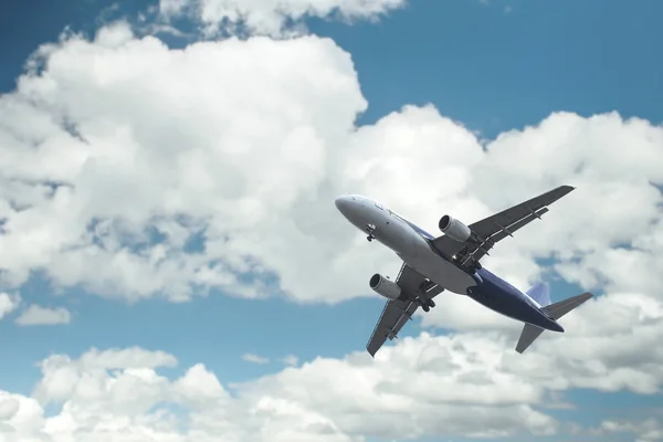 Airplane over the clouds Stock Image