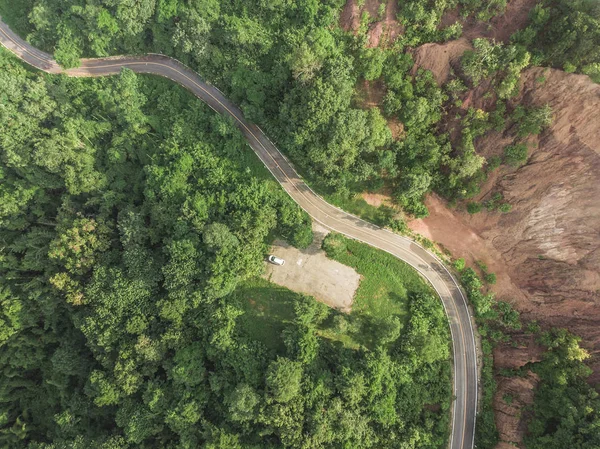 Top View of Rural Road, Path through the green forest and countr