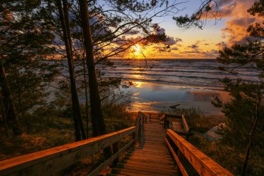 Colorful summer sunset at the Beach Saulkrasti, popular touristic place in Latvia  clipart