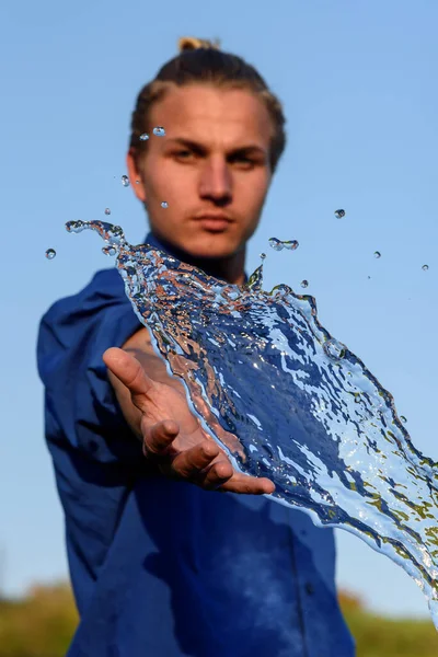 Human hands in splashes of water. Vertical photography. — Stock Photo, Image