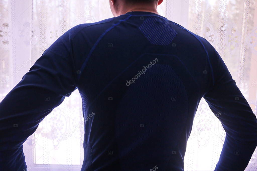 Man thermal underwear, beautiful fabric, fits the body and chest. Details, close-up, daylight.