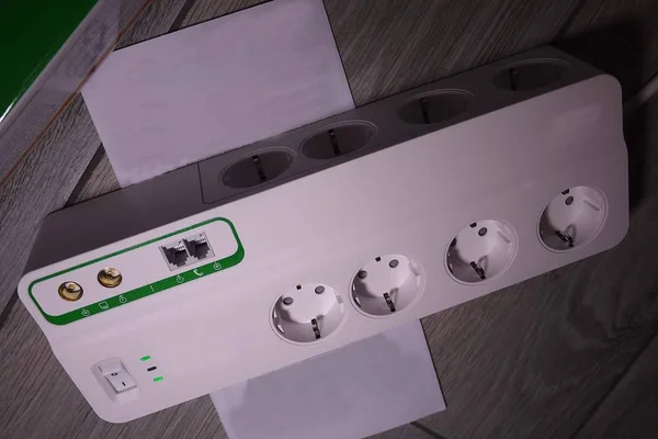 Electric surge protector  Close-up and power supply details. Used at home and in the office