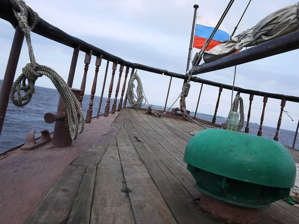 Wooden sailing ship is on the sea. Details and close-up. Sunny weather at sea.