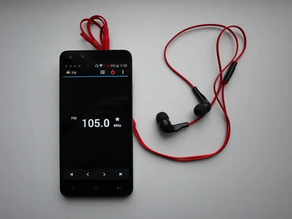 Radio on smartphone. Radio station running in the smartphone app. You can select different FM radio stations.