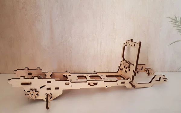 Wooden designer Ugears. It is a model of a car made of wood, only made of wood and assembled without a single iron part.