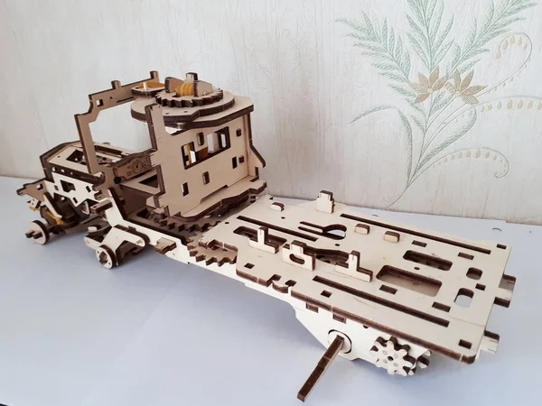 Wooden designer Ugears. It is a model of a car made of wood, only made of wood and assembled without a single iron part.