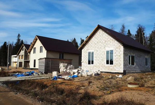 Construction of a cottage village. Construction of modern housing for different people. Details and close-up.