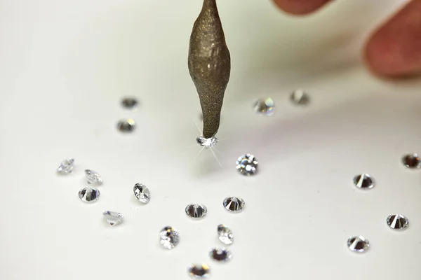 Jewelry production. Special wax setter diamonds on a white background