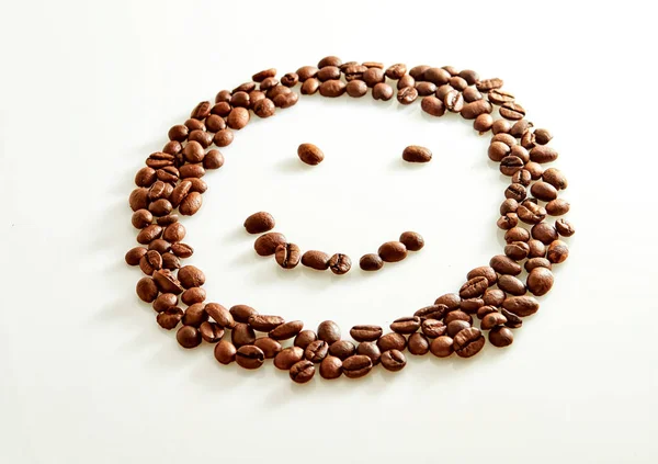 Chicchi di caffè a forma di sorriso isolati su bianco — Foto Stock