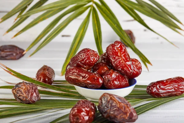 Date fruits with palm leaves, Raw Organic Dates Ready to Eat. Ramadan food concept