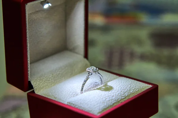 Jewelry production. White gold diamond ring in ice-lit gift box. Wedding, engagement, marriage proposal