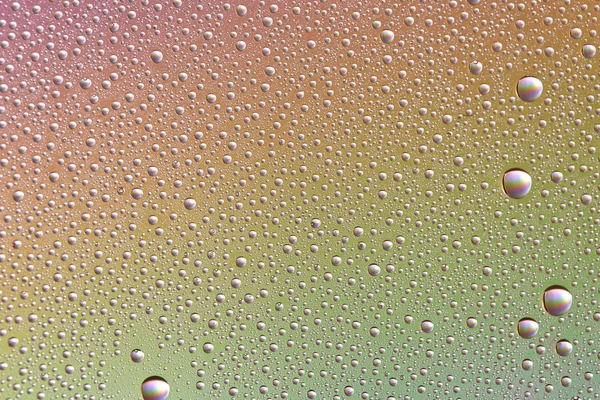 Drops on glass of different sizes and colors on a colored background, texture — Stock Photo, Image