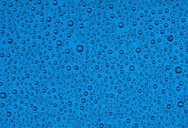 Renkli bir arka plan, doku üzerinde farklı boyut ve renklerde cam damla