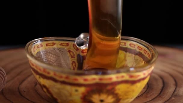 Honey pouring into an apple-shaped bowl, Rosh hashanah - jewish New Year holiday concept — Stock Video