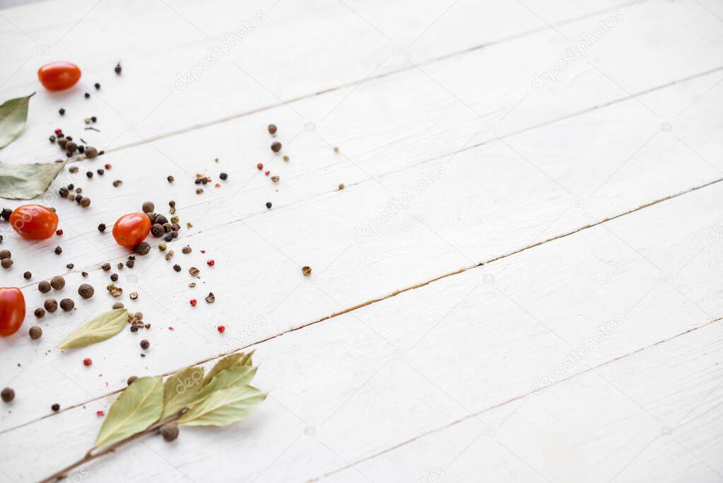 Texture template with empty space for text. Spices scattered on the wooden white table pepper, Basil