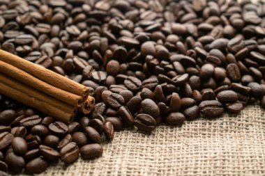 burlap wi arka planda tarçın çubukları ile kahve çekirdekleri