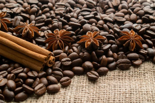 ışık üzerinde yıldız aniseas ve tarçın çubukları ile bütün fasulye kahve