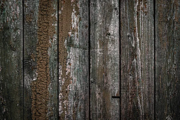 Die Textur des alten Holzzaunes mit abblätternder Farbe und Rissen — Stockfoto