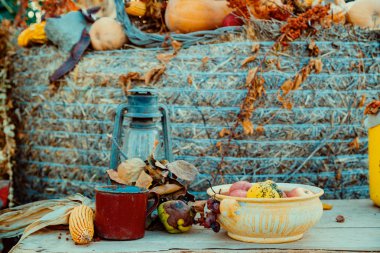 Iron lantern and autumn decoration on the table in a garden clipart