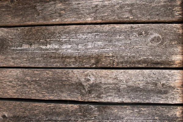木の質感と板の間のギャップを持つ暗い木製のテーブルの表面の背景 — ストック写真