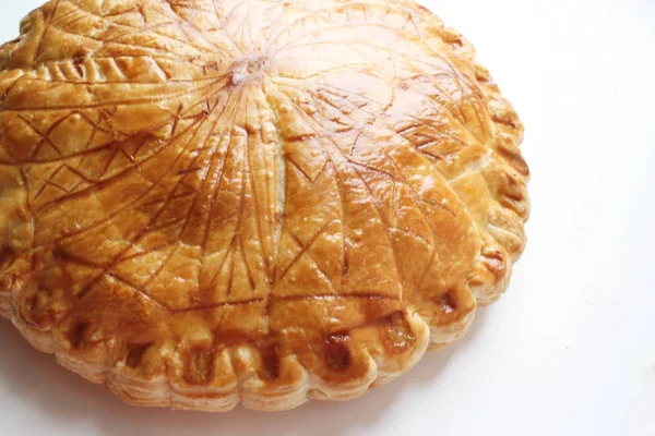 Puff pastry frangipane galette with Celtic runes on white background — Stock Photo, Image