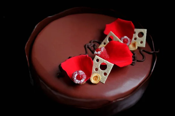 Romantique gâteau aux framboises au chocolat avec pétales de rose, décorations au chocolat blanc et baies fraîches — Photo