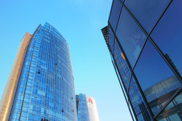 Tall modern glass skyscrapers on blue sky background