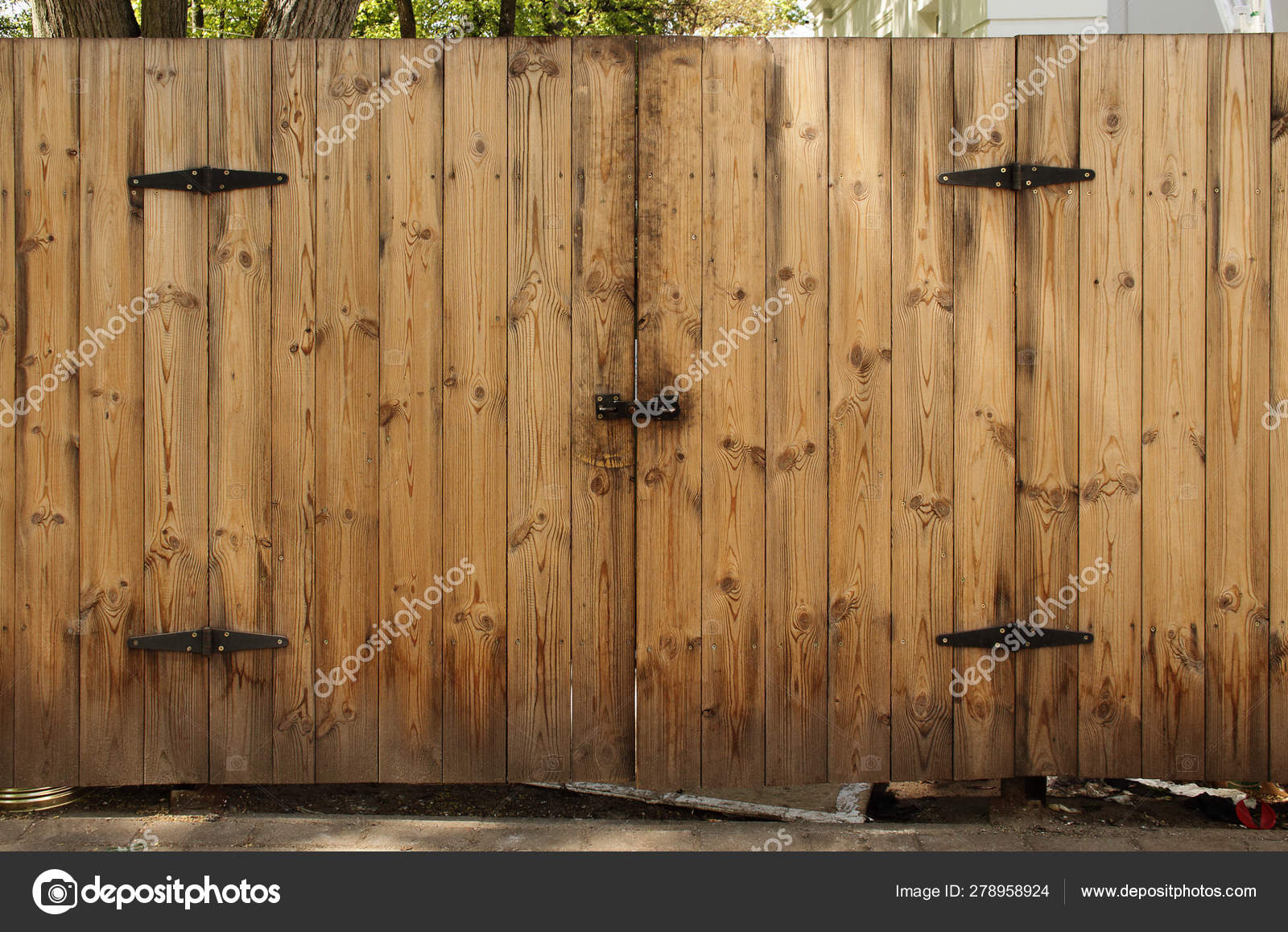 Wooden Plank Fence With Closed Gate Door With Black Iron Details