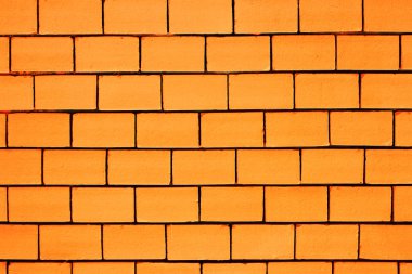 Siyah boşluklar ile turuncu renkli tuğla duvar arka plan
