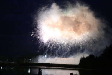 Göl üzerinde Festival havai fişekler. duman ve sis bulutu içinde çok renkli ışıklar. Güzel yansıma su. Ukrayna.