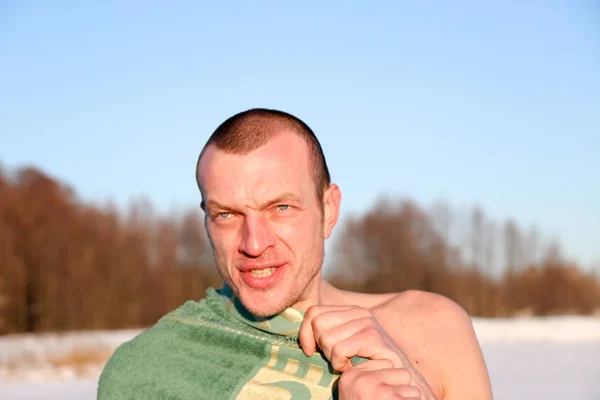 Young Good Looking And Attractive Man With Muscular Body, Taking after taking an ice bath. handsome attractive men showering next to swimming pool. water drops are falling on his torso. Sunny winter day in Ukraine, Shostka