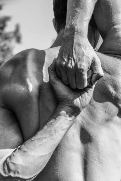 Male hands close-up Black and white image of a muscular man, athletic body, beautiful masculine forms of muscles, relief. Beautiful strong and flexible body, sexy attractive.