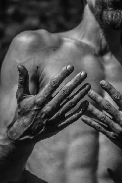 Male hands close-up Black and white image of a muscular man, athletic body, beautiful masculine forms of muscles, relief. Beautiful strong and flexible body, sexy attractive.