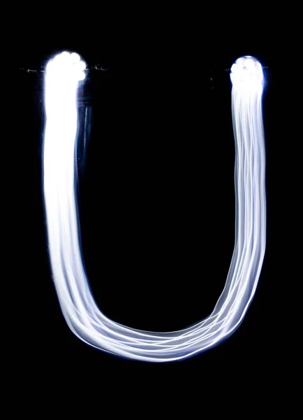 Handwrite letter U, made with light painting technic isolated on black. Light effect font of full alphabet set of upper case letters.