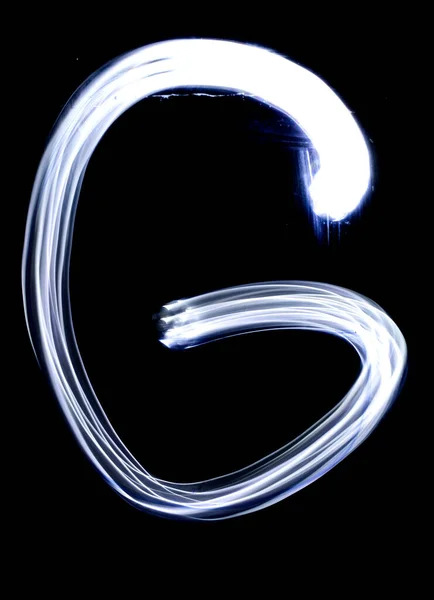 Handwrite letter G, made with light painting technic isolated on black. Light effect font of full alphabet set of upper case letters.