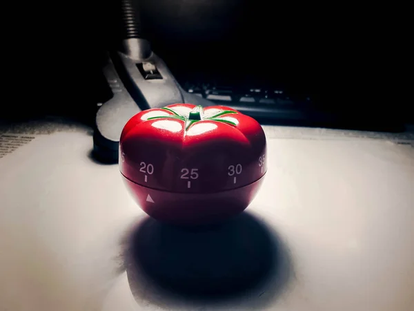 Red tomato shaped kitchen and pomodoro timer. — Stock Photo, Image