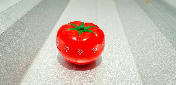 Pomodoro Timer in brushed metal with bold highlight and shadow. Stock Picture