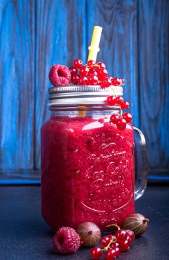 Yaz smoothies, frambuaz, frenk üzümü, glasse mavi zemin üzerine goosberries. Sağlıklı beslenme diyet vejetaryen kavramı.
