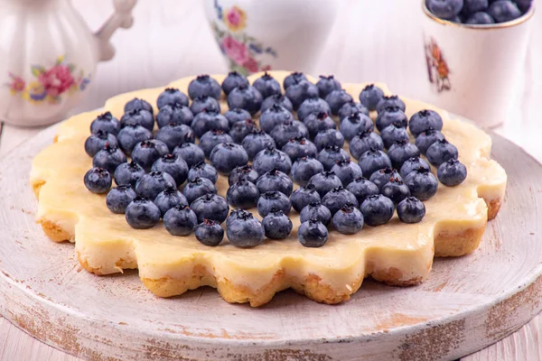 Homemade cheesecake decorated with blueberry over on white woode — Stock Photo, Image